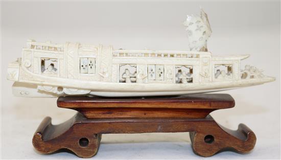 A Chinese ivory model of a boat, early 20th century, 15.5cm, wood stand